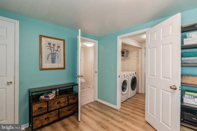 washroom featuring independent washer and dryer and light hardwood / wood-style floors