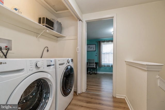 washroom featuring washer and dryer and light hardwood / wood-style flooring