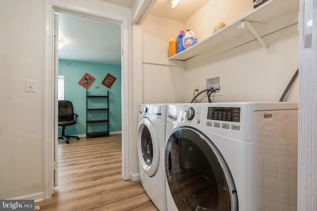 laundry room featuring separate washer and dryer and light hardwood / wood-style flooring