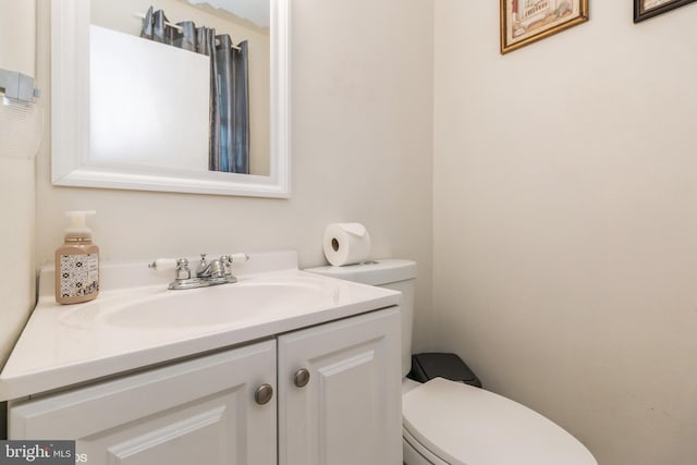 bathroom with toilet and vanity