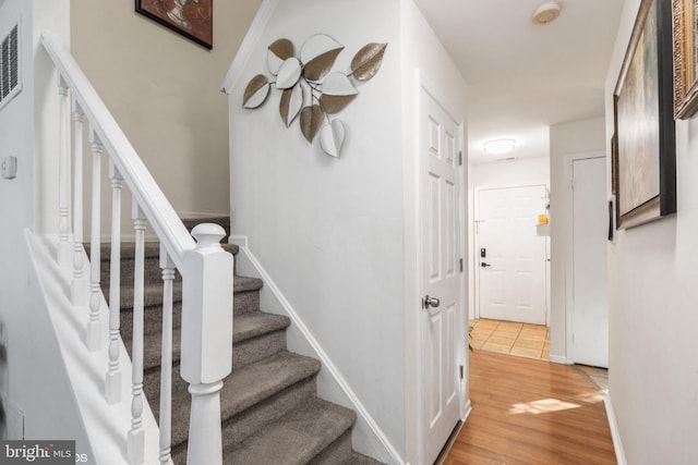 stairs with wood-type flooring