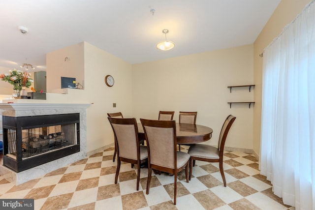 dining room featuring a multi sided fireplace