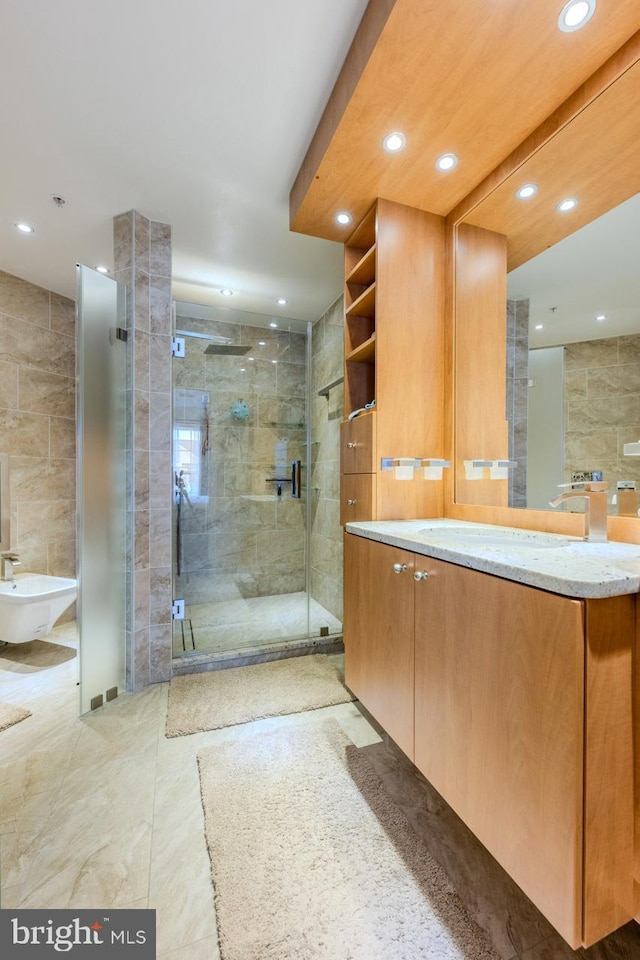 bathroom featuring vanity, tile walls, a bidet, and walk in shower