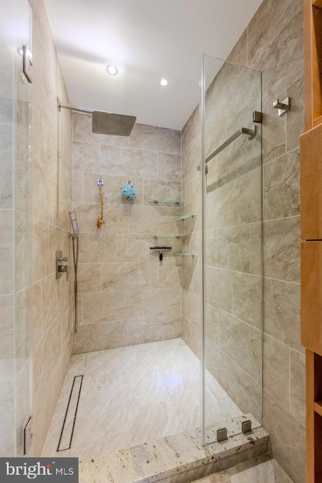 bathroom with a shower with door