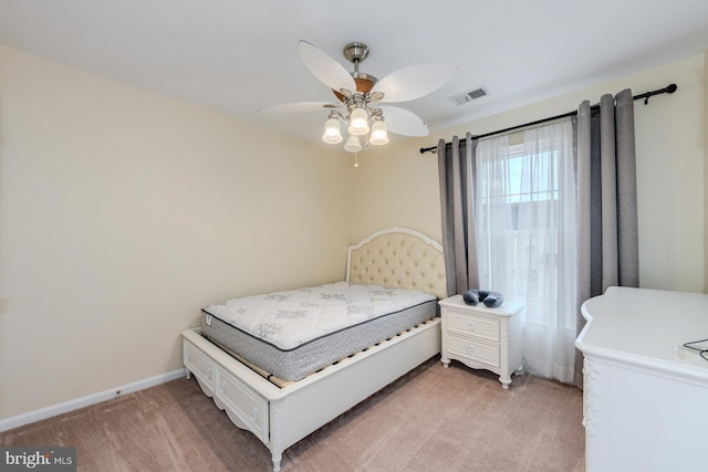 bedroom with ceiling fan and light colored carpet