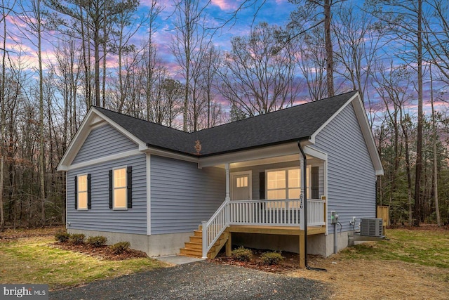 view of front of house with a porch and cooling unit