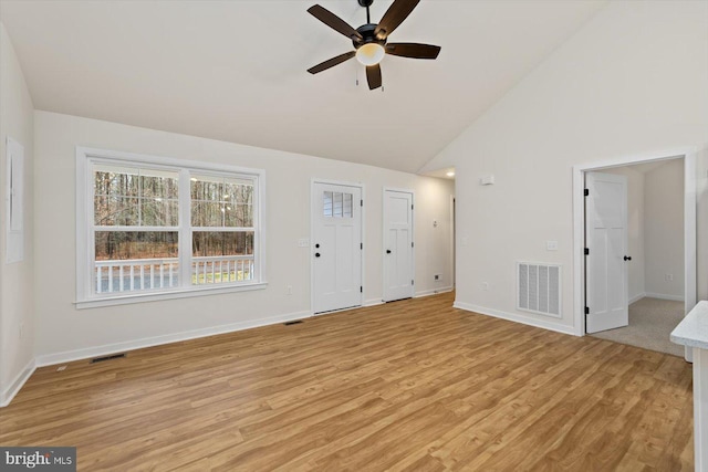 unfurnished living room with ceiling fan, high vaulted ceiling, and light hardwood / wood-style floors