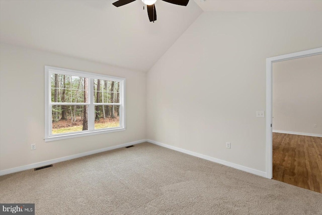 carpeted empty room featuring ceiling fan and lofted ceiling