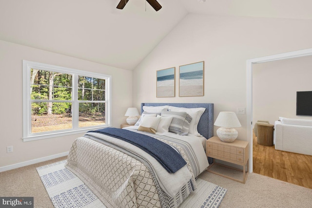 bedroom with carpet flooring, ceiling fan, and vaulted ceiling