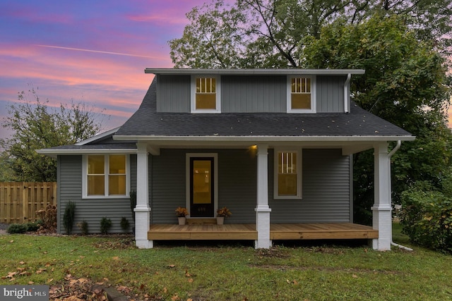 view of front of house with a yard and covered porch