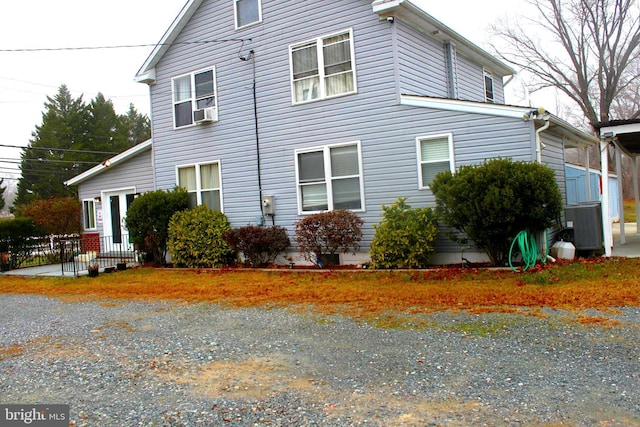 view of side of property featuring central air condition unit and cooling unit