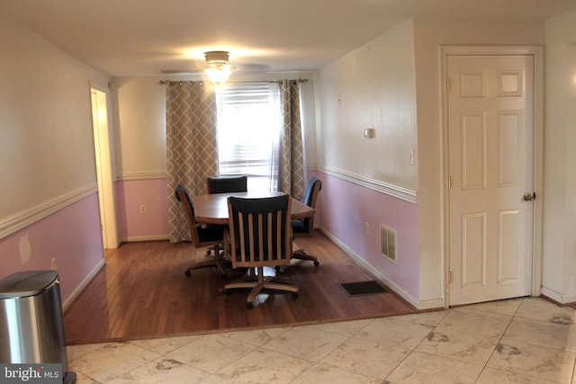 dining space with light hardwood / wood-style flooring and ceiling fan