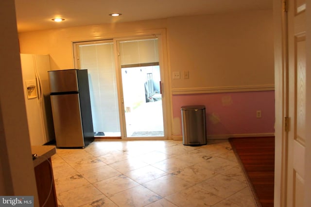 kitchen featuring stainless steel fridge and white fridge with ice dispenser