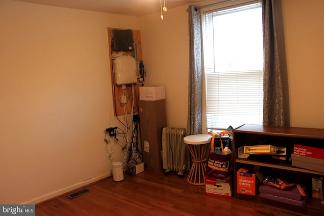 miscellaneous room with hardwood / wood-style floors and radiator