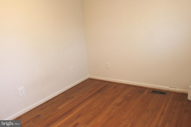 spare room with dark hardwood / wood-style flooring