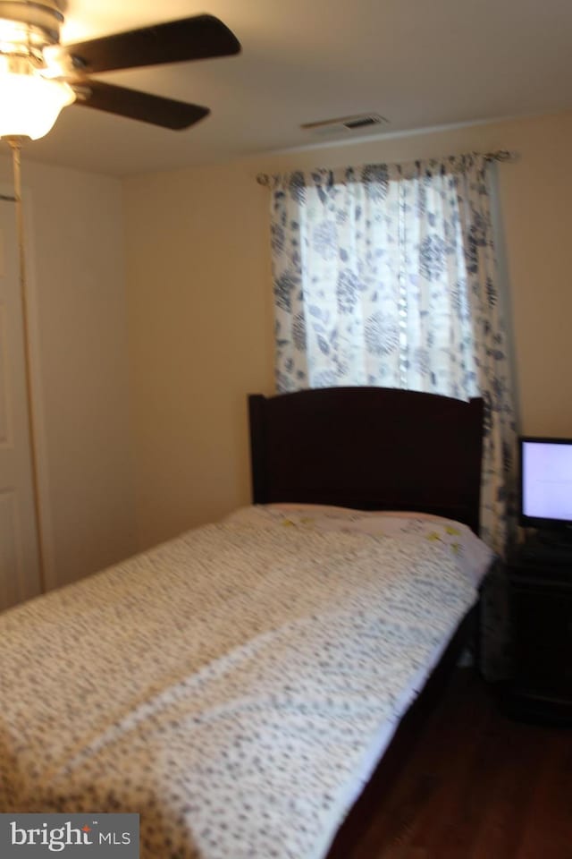 bedroom featuring ceiling fan and hardwood / wood-style flooring