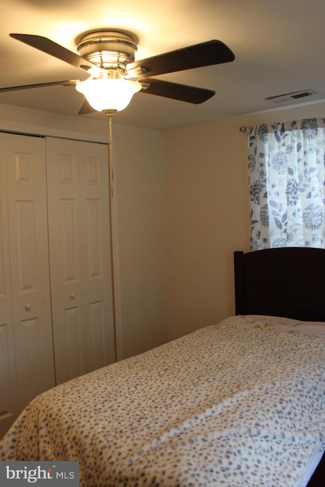 bedroom with ceiling fan and a closet