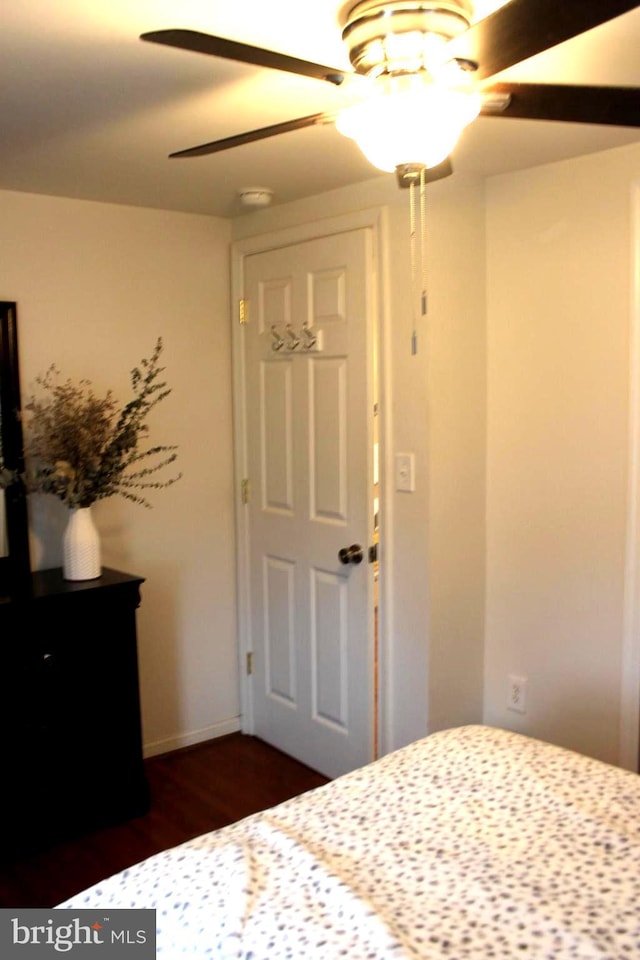 unfurnished bedroom with ceiling fan and dark hardwood / wood-style floors