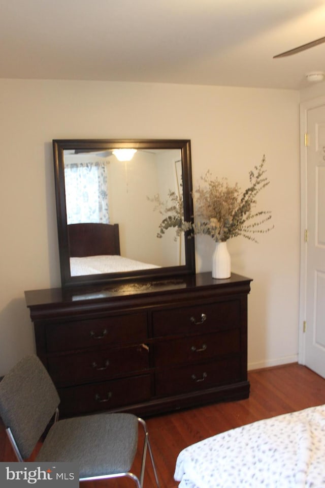 bedroom with dark hardwood / wood-style floors