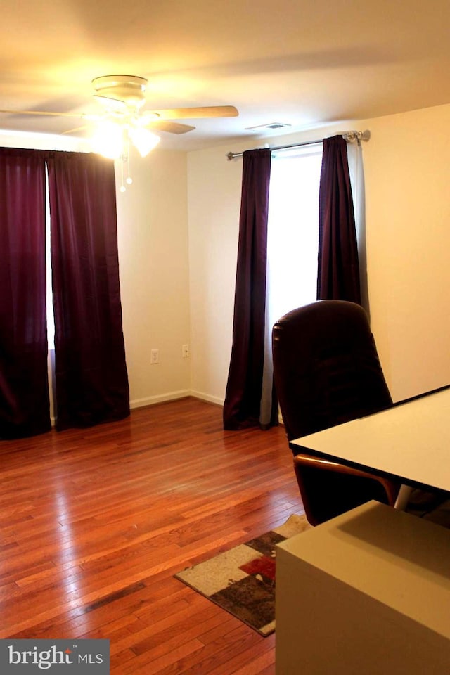 unfurnished bedroom with ceiling fan and wood-type flooring