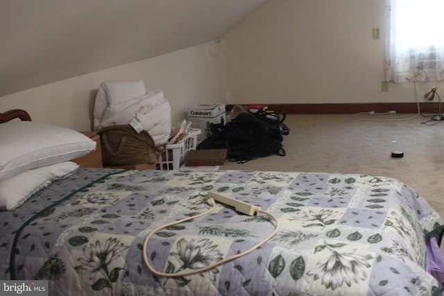 bedroom with carpet floors and lofted ceiling