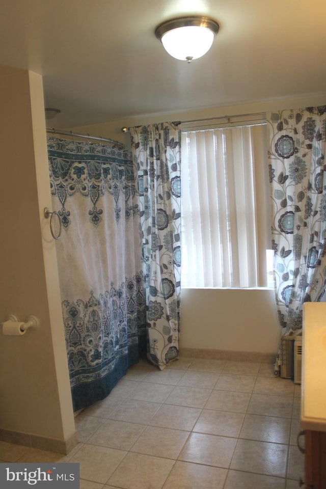 bathroom with tile patterned flooring and curtained shower