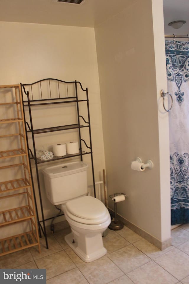 bathroom featuring tile patterned floors and toilet