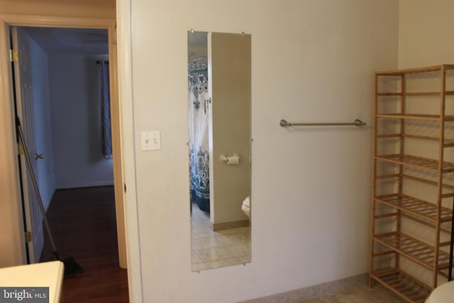 bathroom with tile patterned flooring and toilet