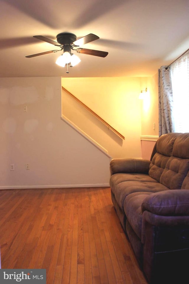 living room with hardwood / wood-style floors and ceiling fan