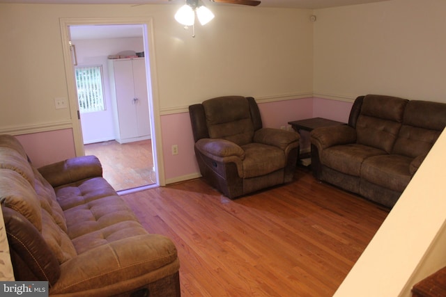 living room featuring hardwood / wood-style flooring and ceiling fan