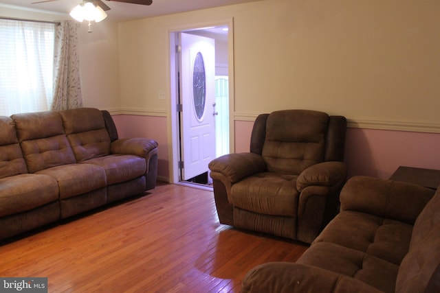 living room with ceiling fan and wood-type flooring