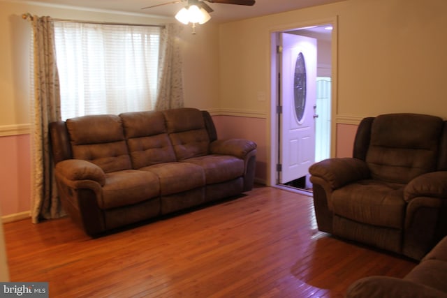 living room featuring hardwood / wood-style floors and ceiling fan