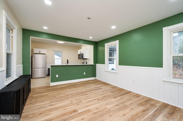 interior space featuring plenty of natural light and light hardwood / wood-style floors