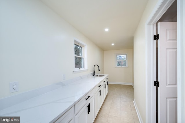 interior space featuring light tile patterned flooring and sink