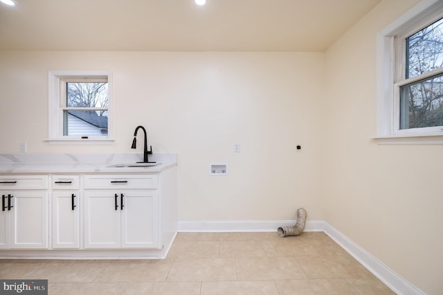 clothes washing area featuring hookup for an electric dryer, plenty of natural light, sink, and washer hookup