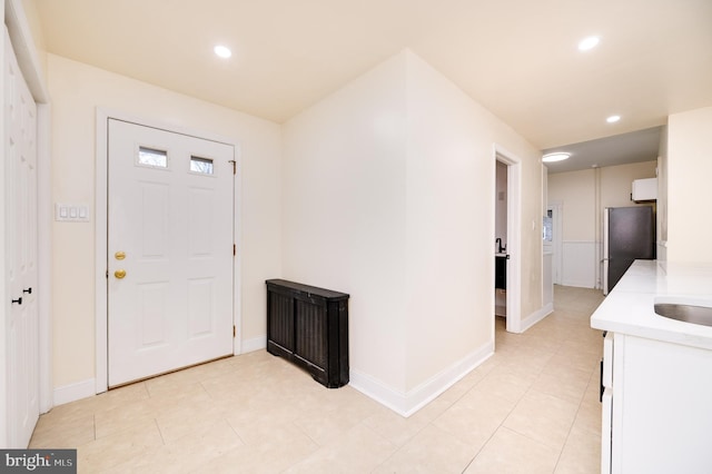 tiled foyer featuring sink