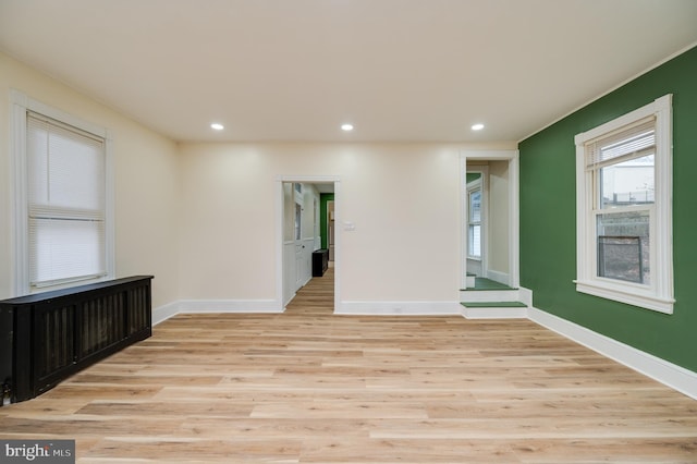 unfurnished room with light hardwood / wood-style flooring