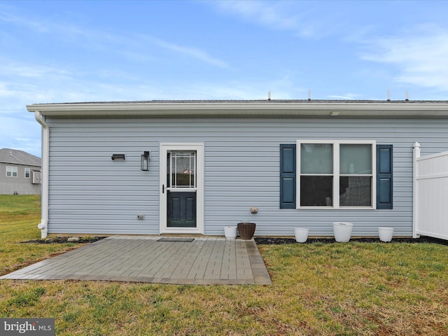 rear view of house with a yard and a patio