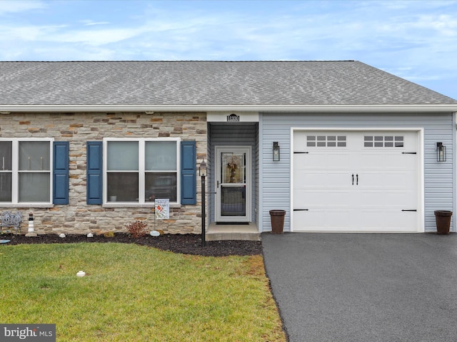 single story home featuring a garage and a front yard