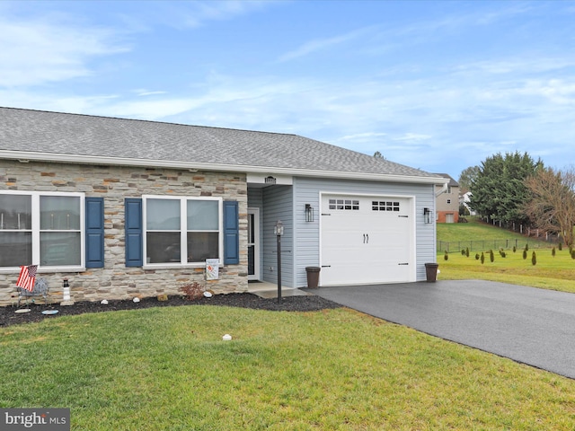 ranch-style house featuring a garage and a front yard