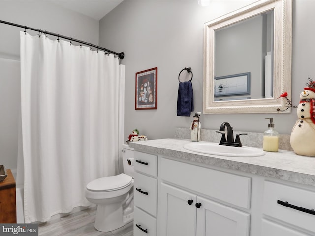 bathroom featuring hardwood / wood-style floors, vanity, and toilet