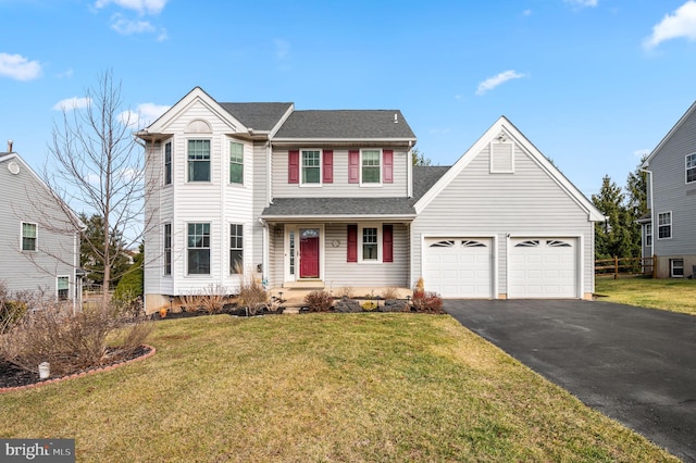 view of front of home with a front lawn and a garage