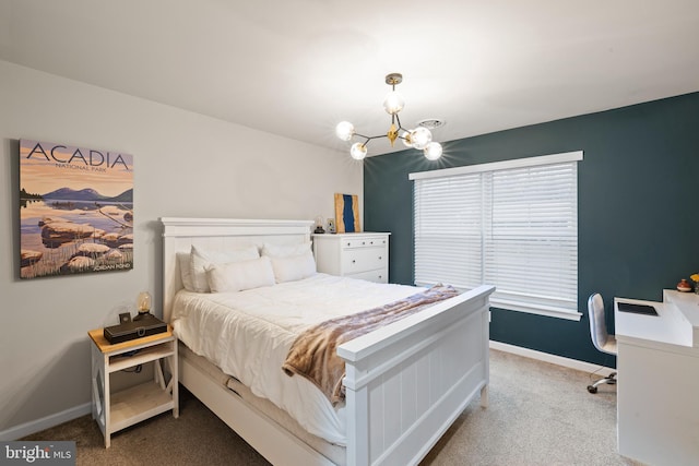 carpeted bedroom featuring a chandelier