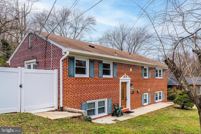 rear view of house with a yard