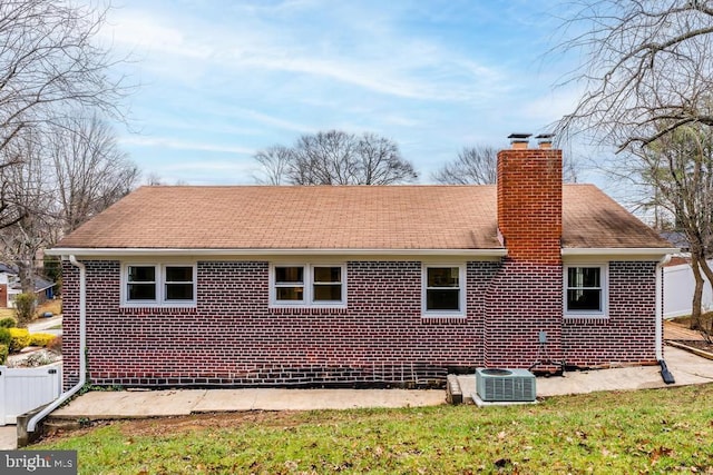 exterior space with a yard and central air condition unit