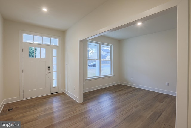 entryway featuring visible vents, baseboards, wood finished floors, and recessed lighting