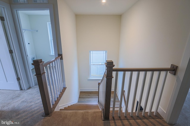 staircase with carpet flooring and baseboards