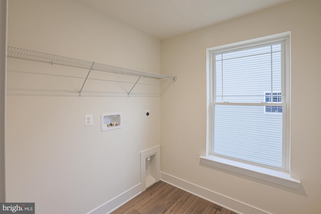 washroom with dark wood finished floors, hookup for a washing machine, hookup for an electric dryer, laundry area, and baseboards