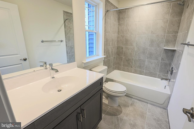 bathroom featuring toilet, tile patterned floors, vanity, and bathing tub / shower combination