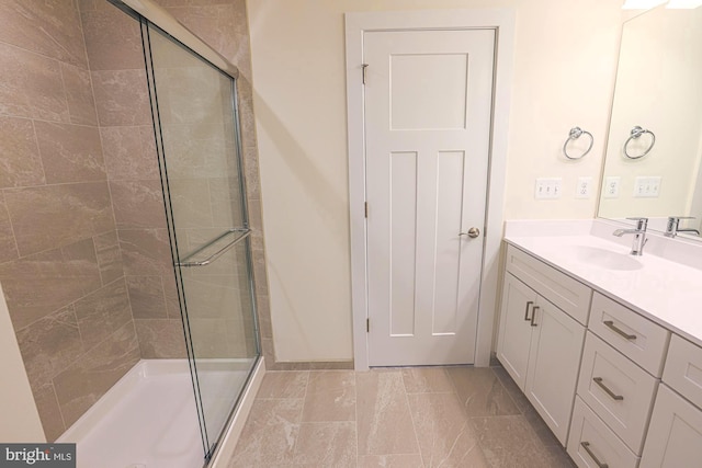 bathroom featuring a stall shower and vanity